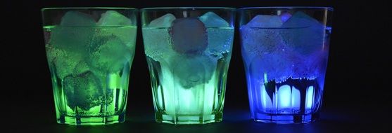 banner with illuminated glasses with ice cubes