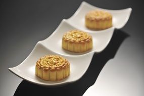 three little sweet cakes called "mooncake"