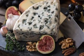 cheese on a plate with walnuts and figs