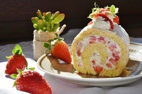 Roll cake with the strawberry and cream and stawberries