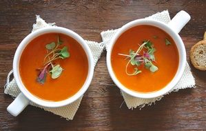 two healthy homemade soups in white cups