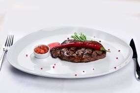 Steak in the restaurant on a white plate