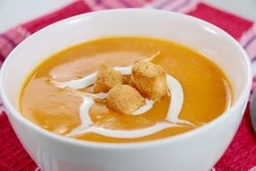 pumpkin soup with cream in a bowl
