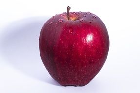 wet red apple on white background