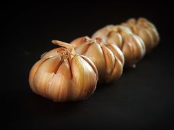 four heads of garlic on a table