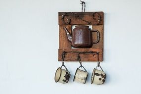 Cup shelf with decorative kettle