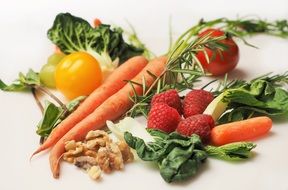 Carrot Kale Walnuts and Tomatoes colourful harvest closeup