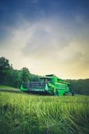 green big combine in the field