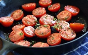 Tomatoes with green herbs on pan