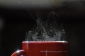 hot red Coffee Cup on a black background close-up