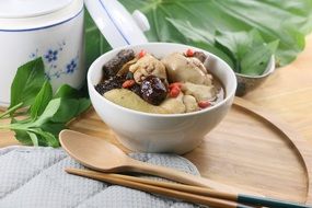 chinese food in white bowl on wooden board