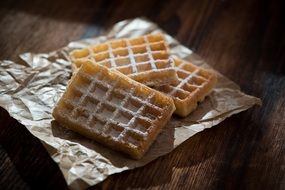 waffles with icing sugar on paper
