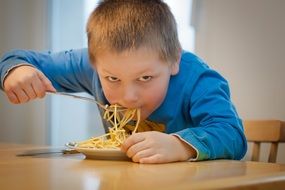 boy eating noodles