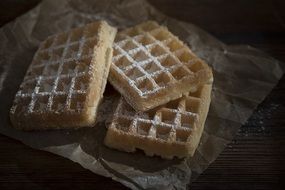 sweet waffles with powdered sugar on the table