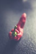 red chili peppers on a black table close-up on blurred background