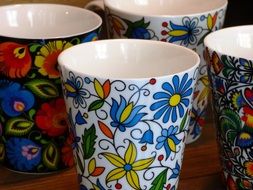 ceramic cups with colorful drawings