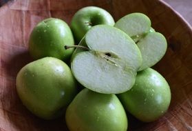 green apples in the wood bowl