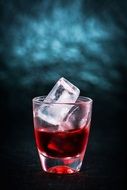 red drink in a glass with ice