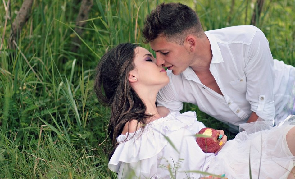 kiss of a couple in love in nature