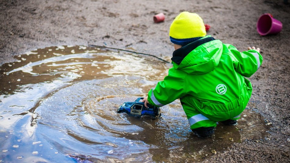 boy playing in the puddle