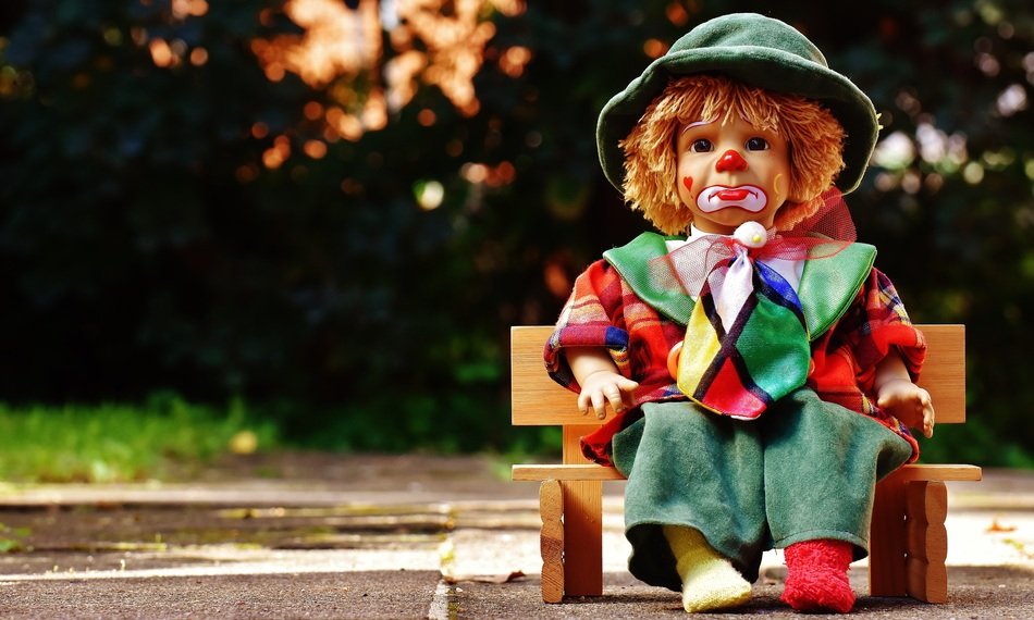 Sad Doll Clown Sitting On The Bank