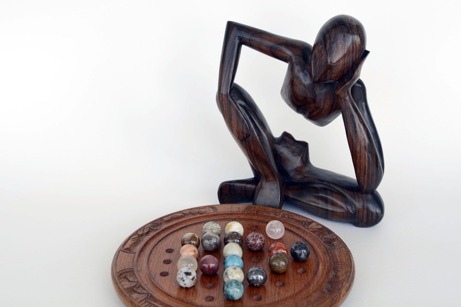 wooden figurine of the thinker