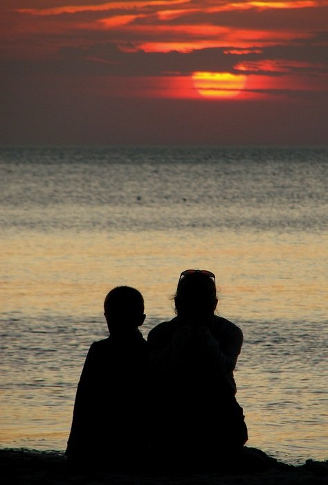 mother and son at twilight on the beach