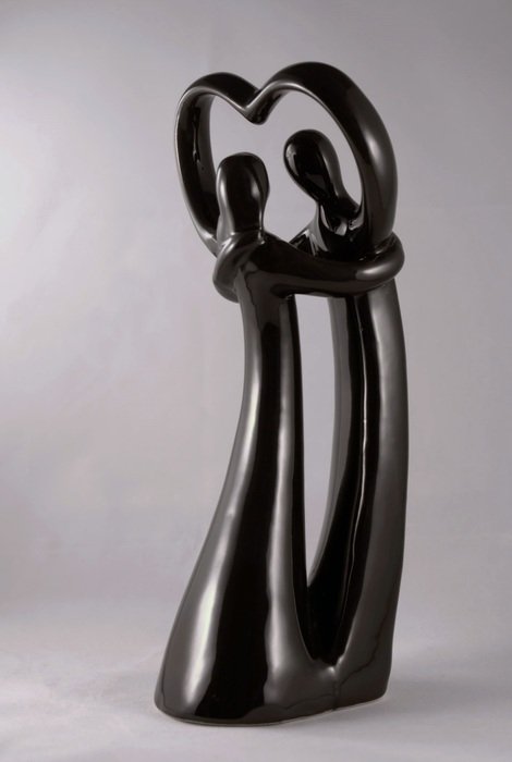 black sculpture of a couple in love