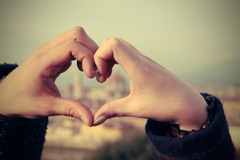 i love Florence, Hands in heart form in front of blurred cityscape