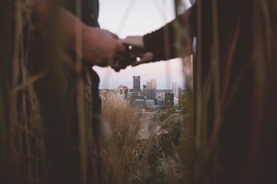 hands of lovers on the background of the cityscape in the distance