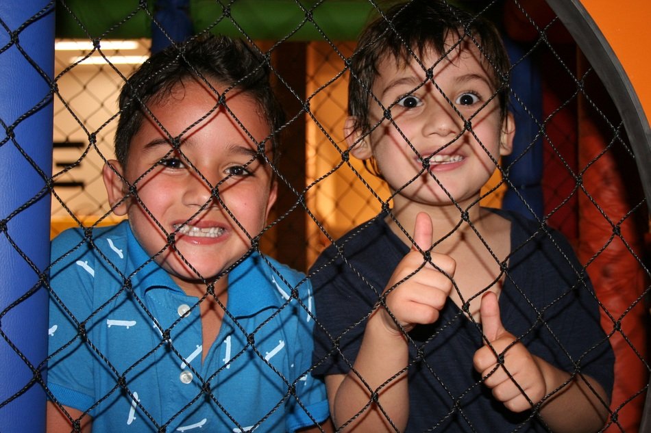 children play behind the net