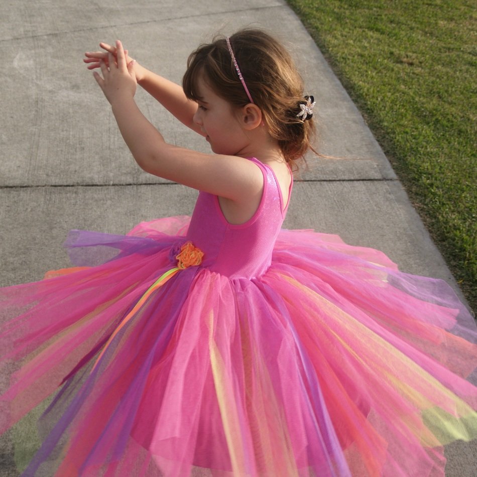twirling young girl in beautiful dress
