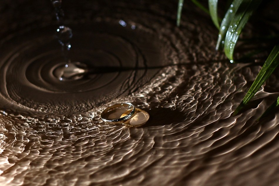 wedding ring in spray on the sand
