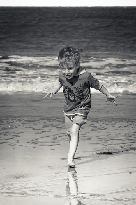 happy wet baby on the beach