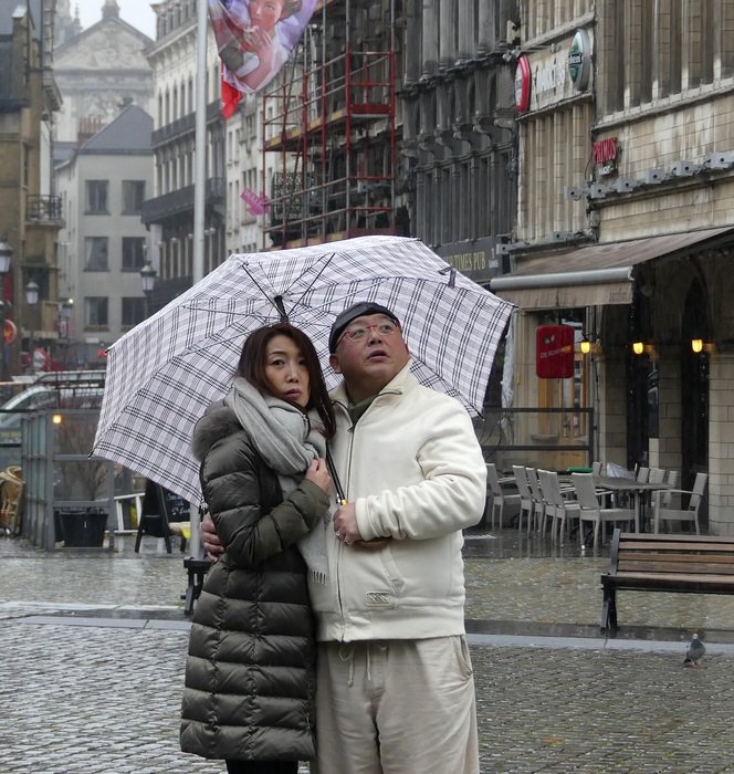 Couple with umbrella under the rain