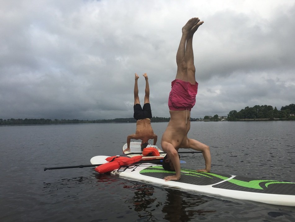Doing yoga man on a paddleboard