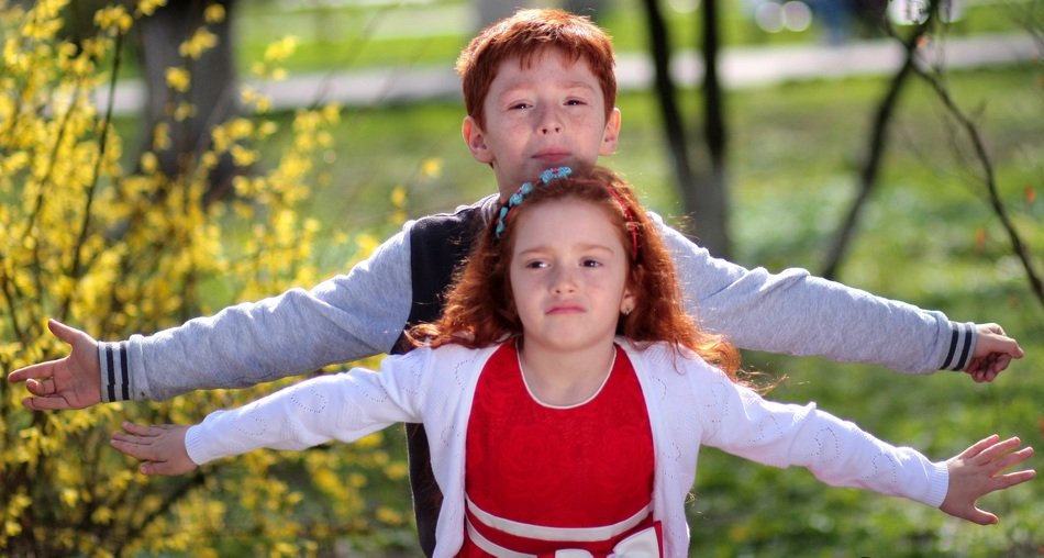 redhead brother and sister in spring nature
