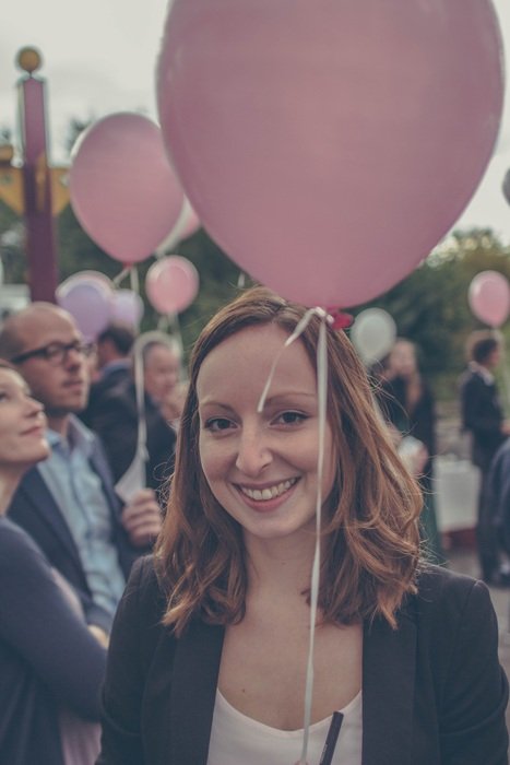 people with pink balloons close up