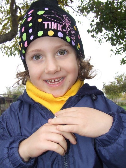 girl in a hat with inscriptions on the background of nature