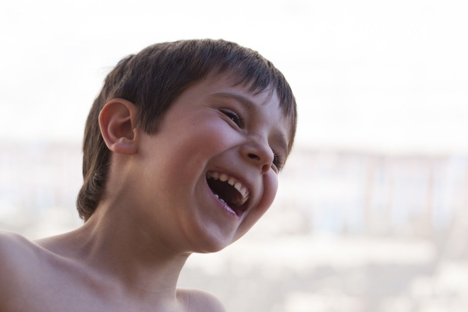 boy laughs on the street