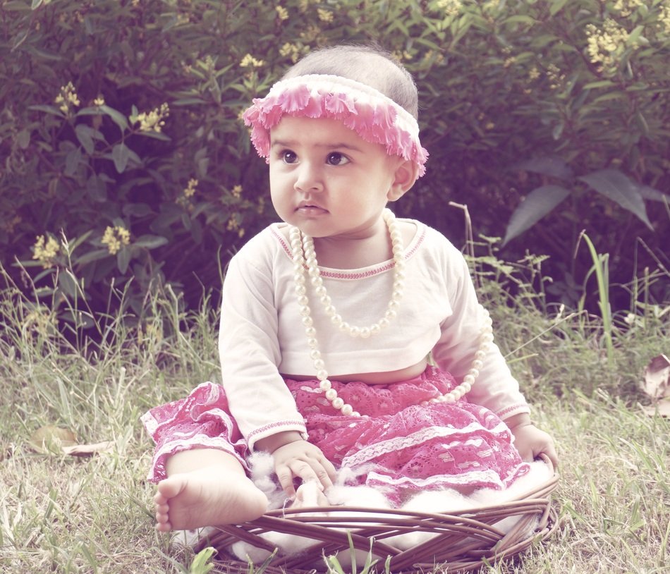 charming little girl in a dress in nature