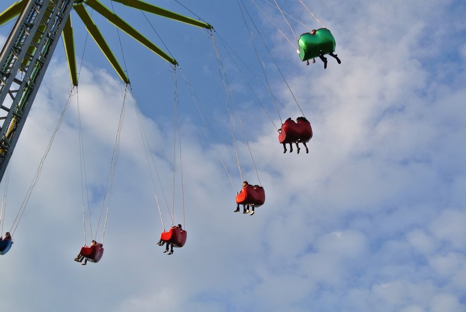people on the carousel in the park