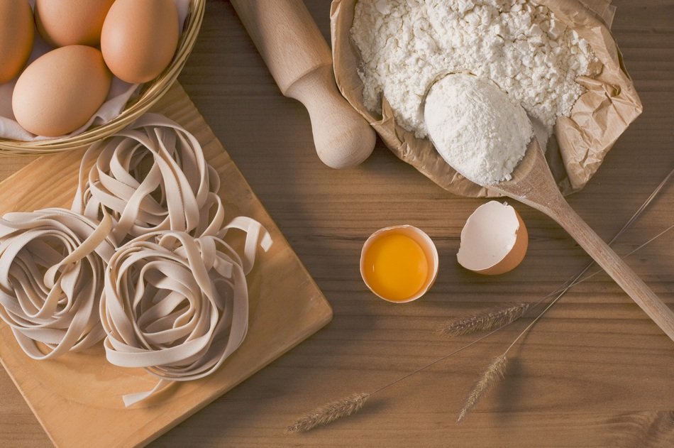 noodles, eggs and flour on the table