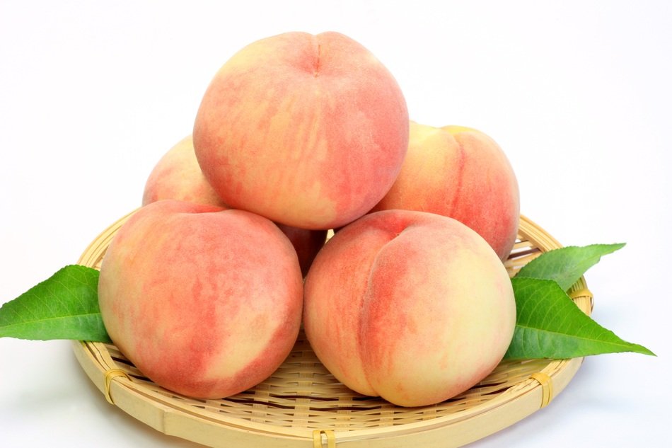 ripe peaches on a wicker plate