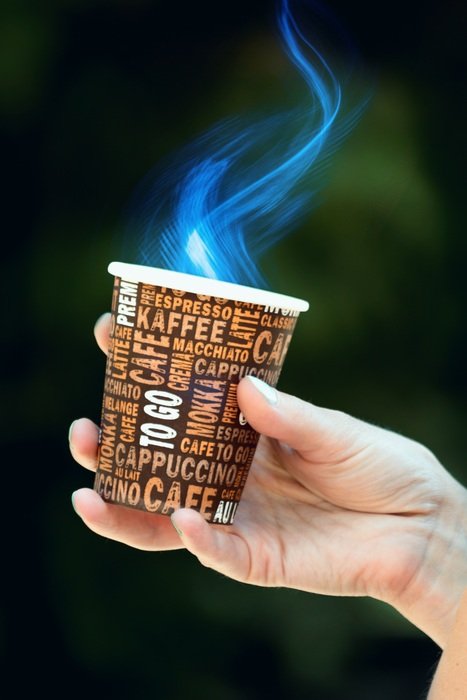 drink in a paper cup in hand