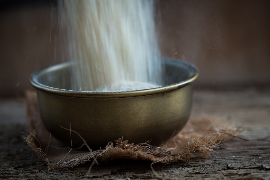 filling brass bowl by wheat
