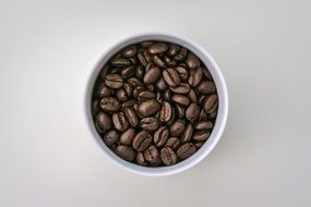 coffee beans in a white cup