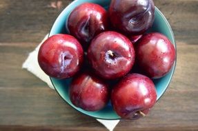 Red Plum Fruits on plate