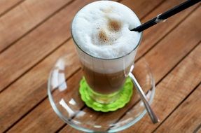 Macchiato Coffee in glass close-up on blurred background