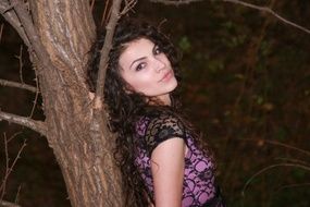 GIrl near the tree in the forest in autumn